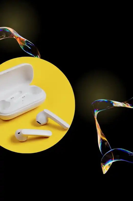 White wireless earbuds and their open charging case.